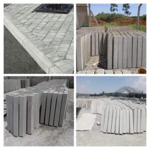 Precast concrete road channels installed along cabro paving and road edges.