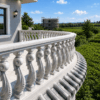 Trojan Horse concrete balustrades installed on a luxury curved balcony overlooking a landscaped outdoor environment.